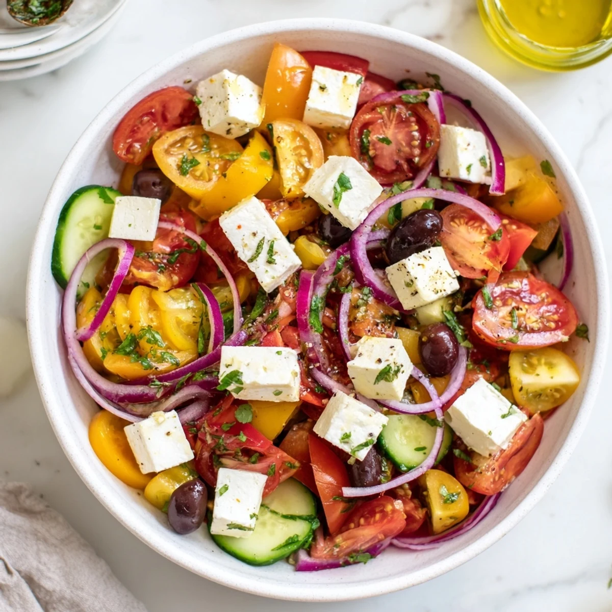 Fresh, vibrant Cucumber, Tomato, and Avocado Salad with feta, a colorful Mediterranean dish.