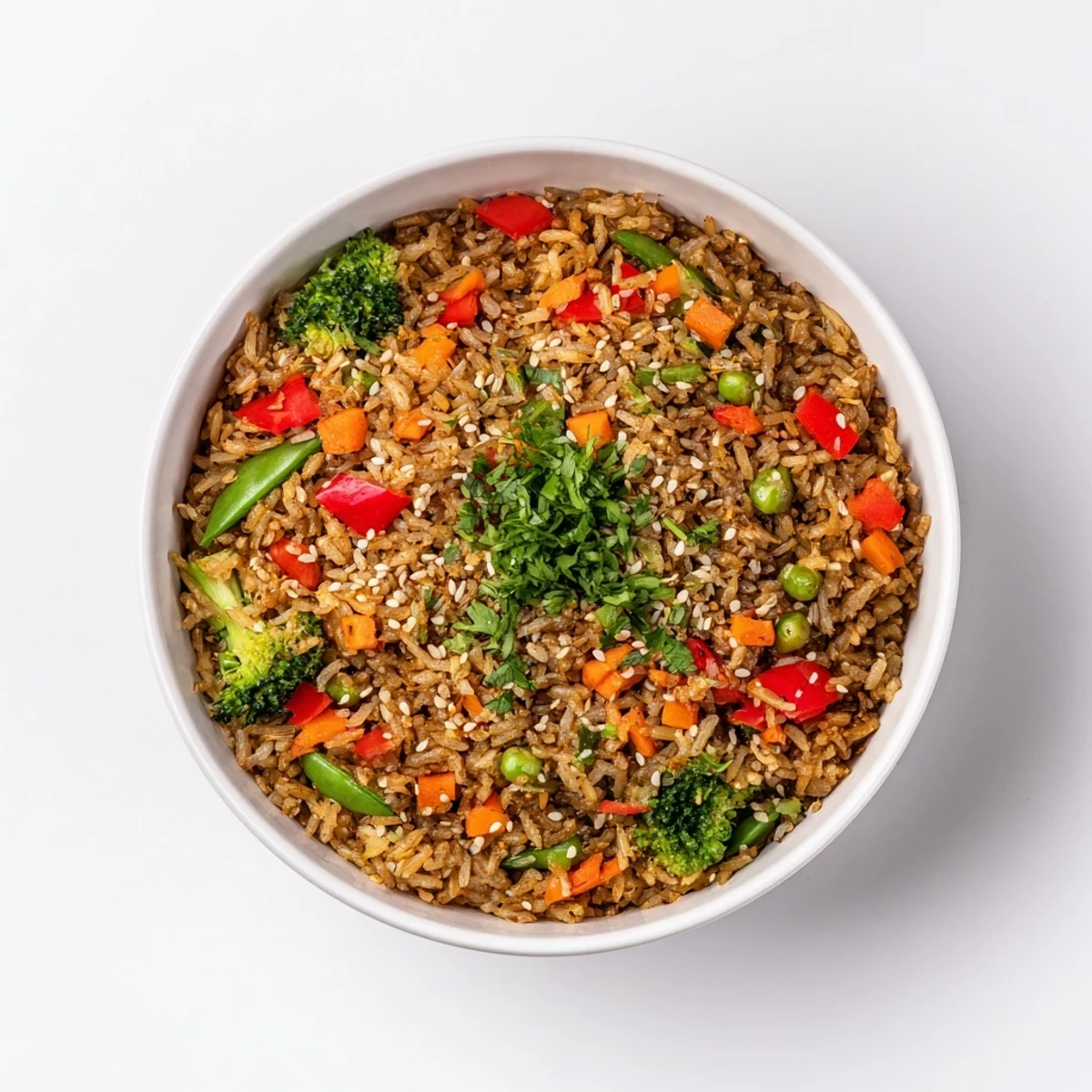 A steaming bowl of Crispy Vegetable Fried Rice showcases perfectly crisped rice with vibrant stir-fried vegetables and herbs.