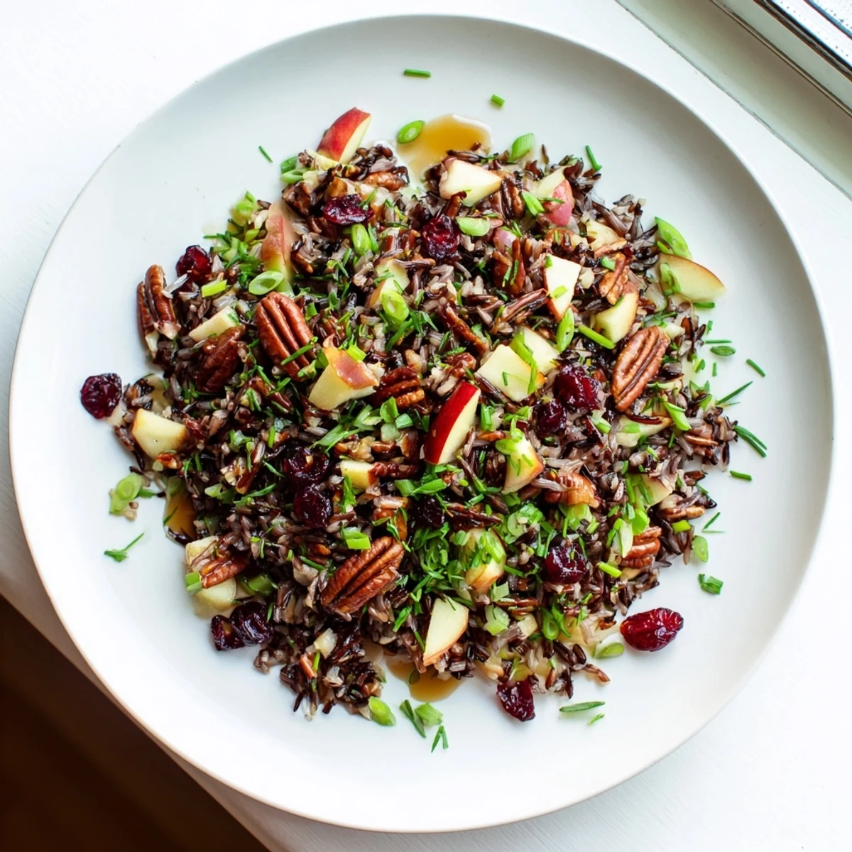 Serving suggestion for Wild Rice Harvest Salad, a hearty vegetarian side perfect for fall gatherings.