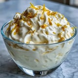 Silky Lemon Fool layered with whipped cream, garnished with a shortbread biscuit for a classic British dessert.