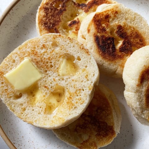 Freshly baked sheet pan English muffins, with a dusting of cornmeal, promise a beautiful texture.