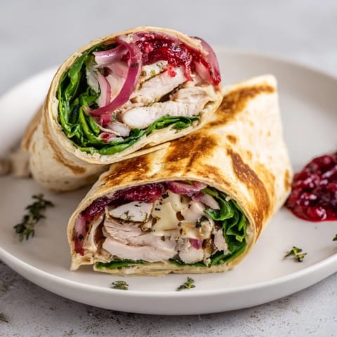 Golden-toasted Chicken and Brie Holiday Wrap, filled with savory chicken and creamy brie, a holiday favorite.
