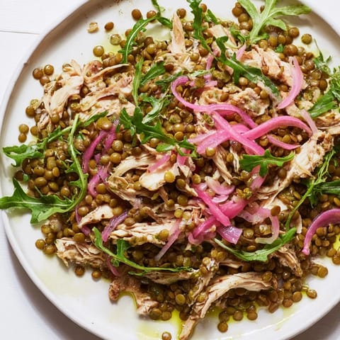 Bright bowl of Lentil & Chicken Spring Salad featuring pickled onions and a zesty mustard dressing.