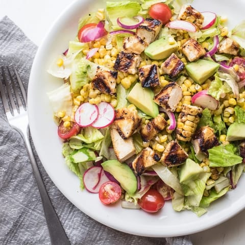 Fresh avocado and sliced radishes top the Roasted Corn & Chicken Chopped Salad tossed in zesty lime dressing.