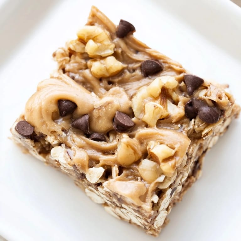 Freshly made, no-bake Peanut Butter Banana Oat Bars, served on parchment paper, a healthy American treat.