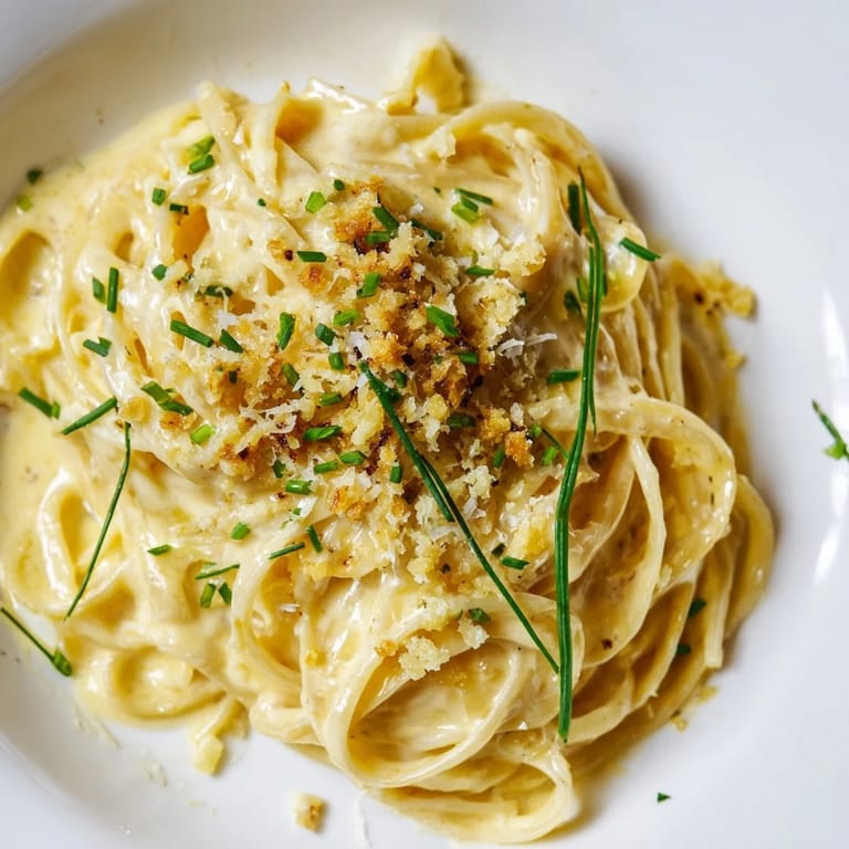 Creamy Miso Butter Pasta features savory noodles glistening with rich, garlic-infused sauce, ready to serve with lemon.