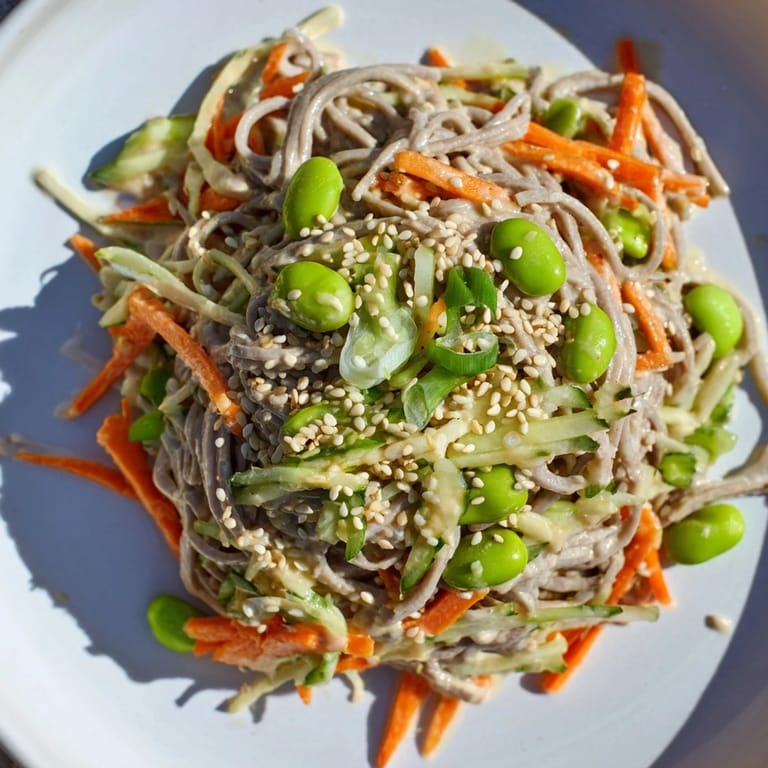 Cold Asian sesame noodle salad, garnished with sesame seeds and fresh cilantro, is ready to serve.