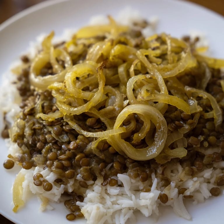 A warm, inviting image of Lebanese Mjadra: perfectly cooked lentils, rice, with spice aromas.