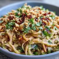 Vibrant Thai Peanut Noodle Salad with fresh cilantro and crunchy peanuts.